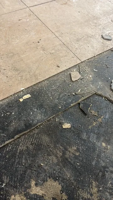 Black bitumen mastic floor removal in a SW19 flat